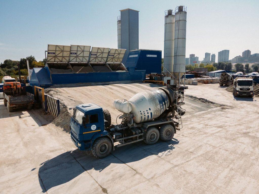Concrete trucks at a batching plant in Novosibirsk under a clear sky