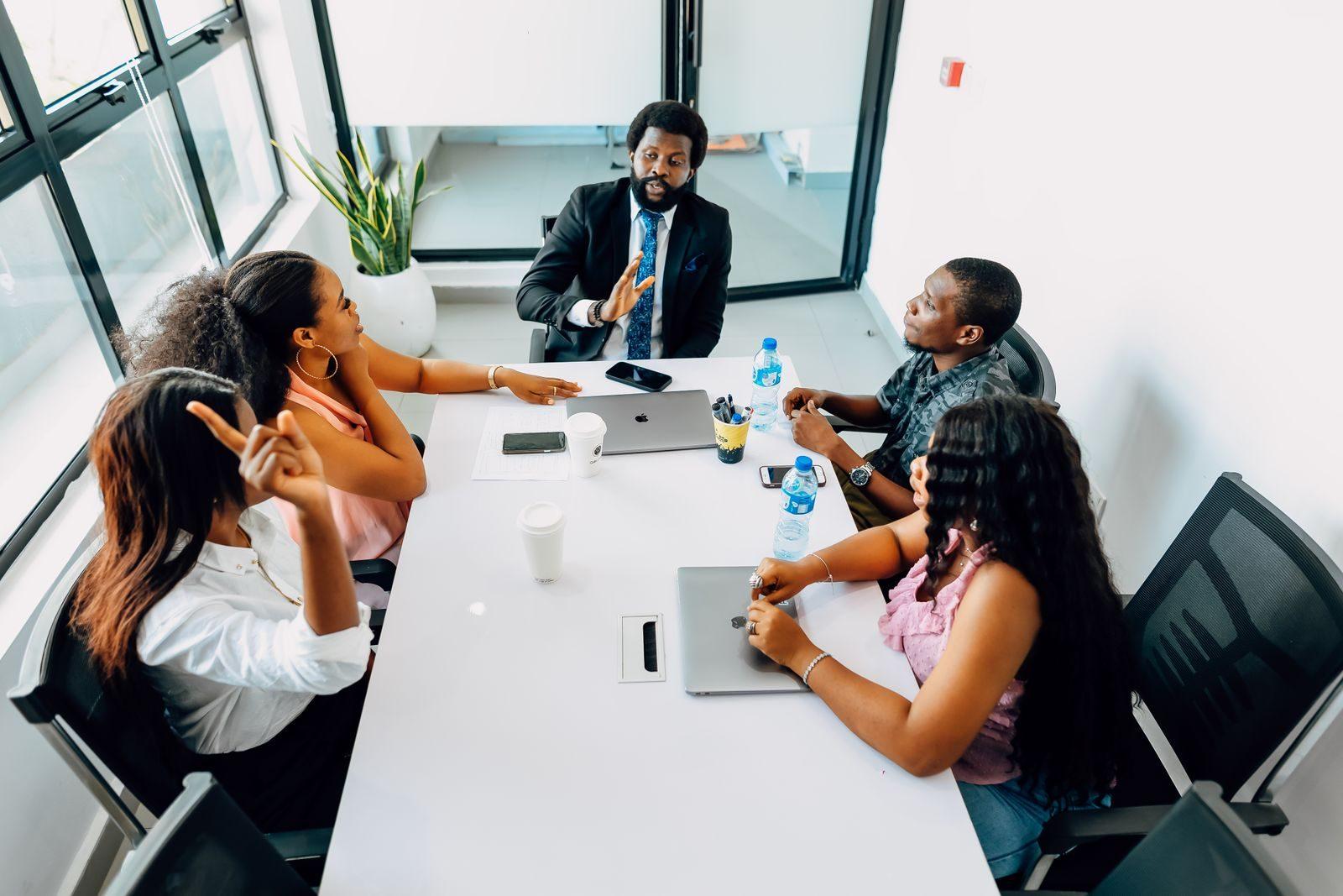 Business professionals engage in a collaborative meeting in a bright Lagos office.