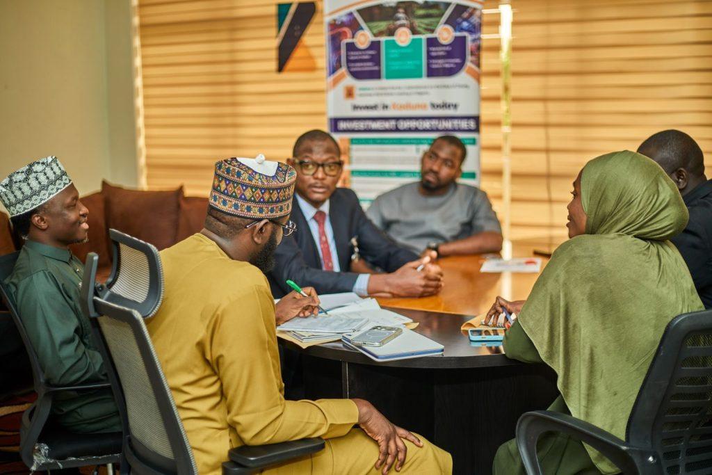 Photo by mk_photoz Professionals engaged in a business meeting in Kaduna, Nigeria discussing investment opportunities.