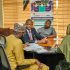 Professionals engaged in a business meeting in Kaduna, Nigeria discussing investment opportunities.