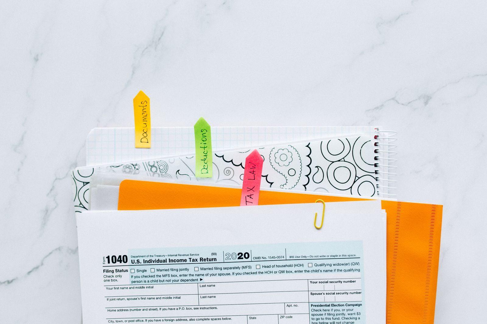 Colorful tabs organizing tax documents for easy filing and reference.