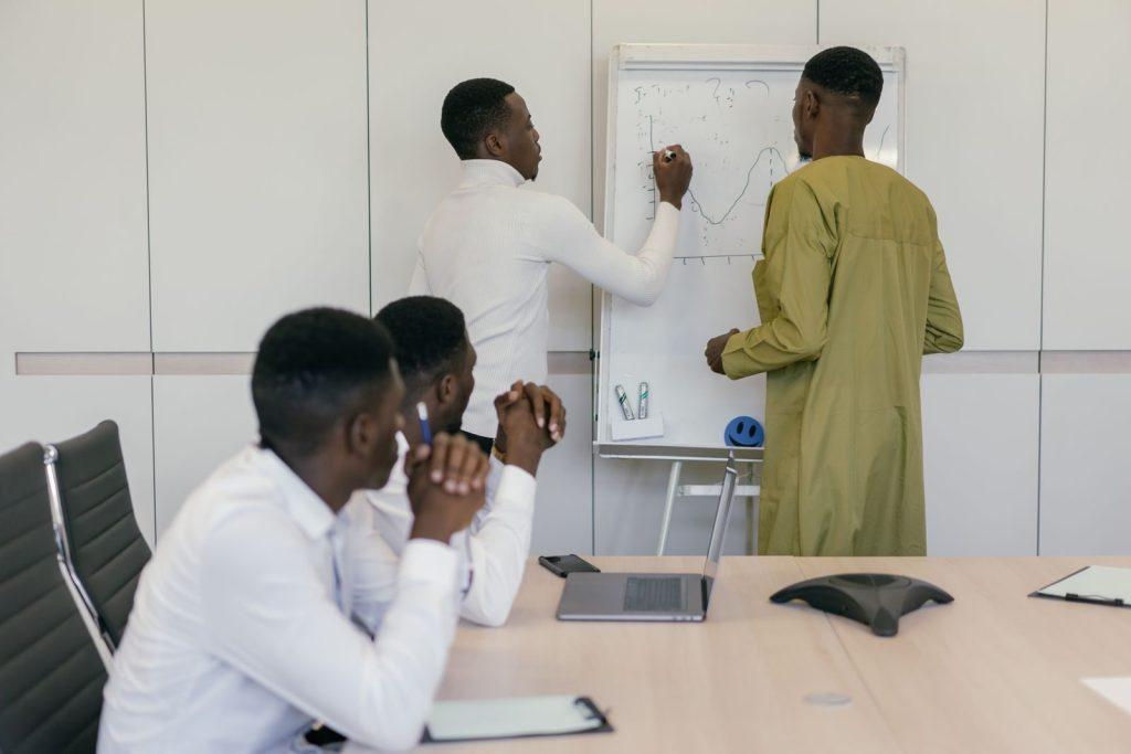 Business professionals brainstorming strategy in a modern office setting.