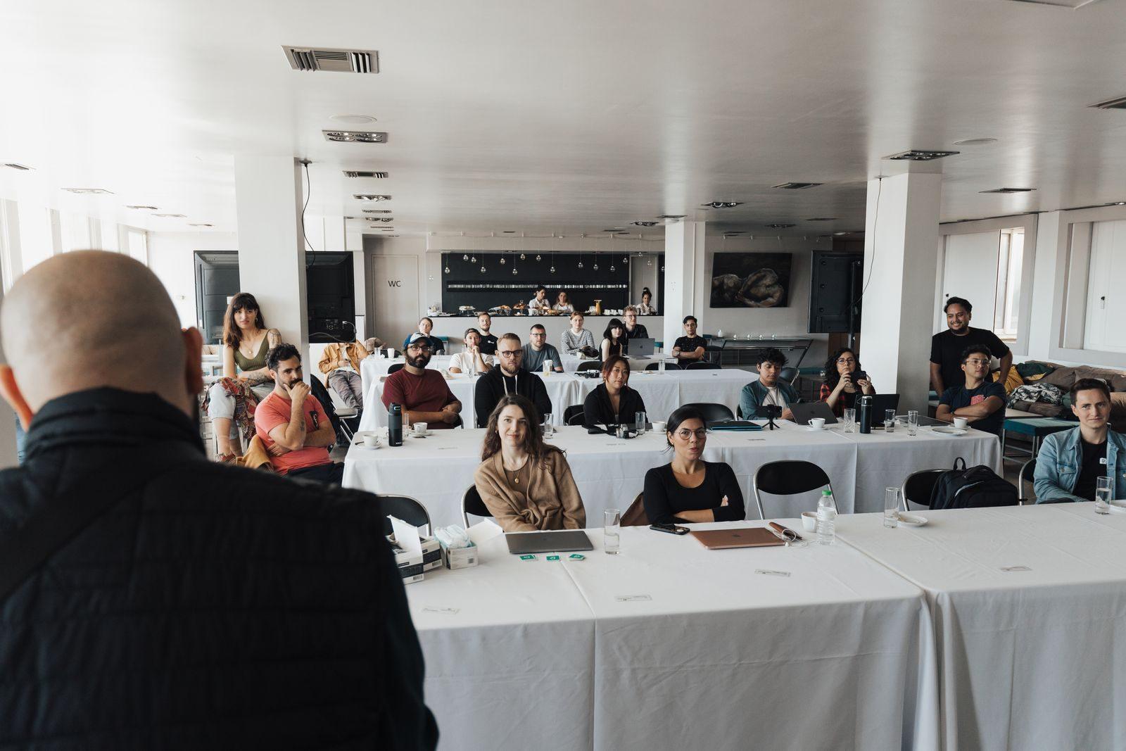 A diverse group of business professionals attending a presentation in a modern conference room.