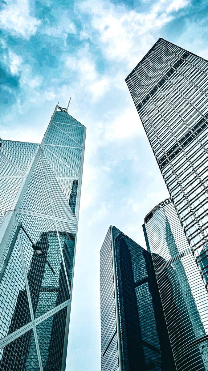 Uplifting view of modern skyscrapers on Hong Kong Island against a blue sky.