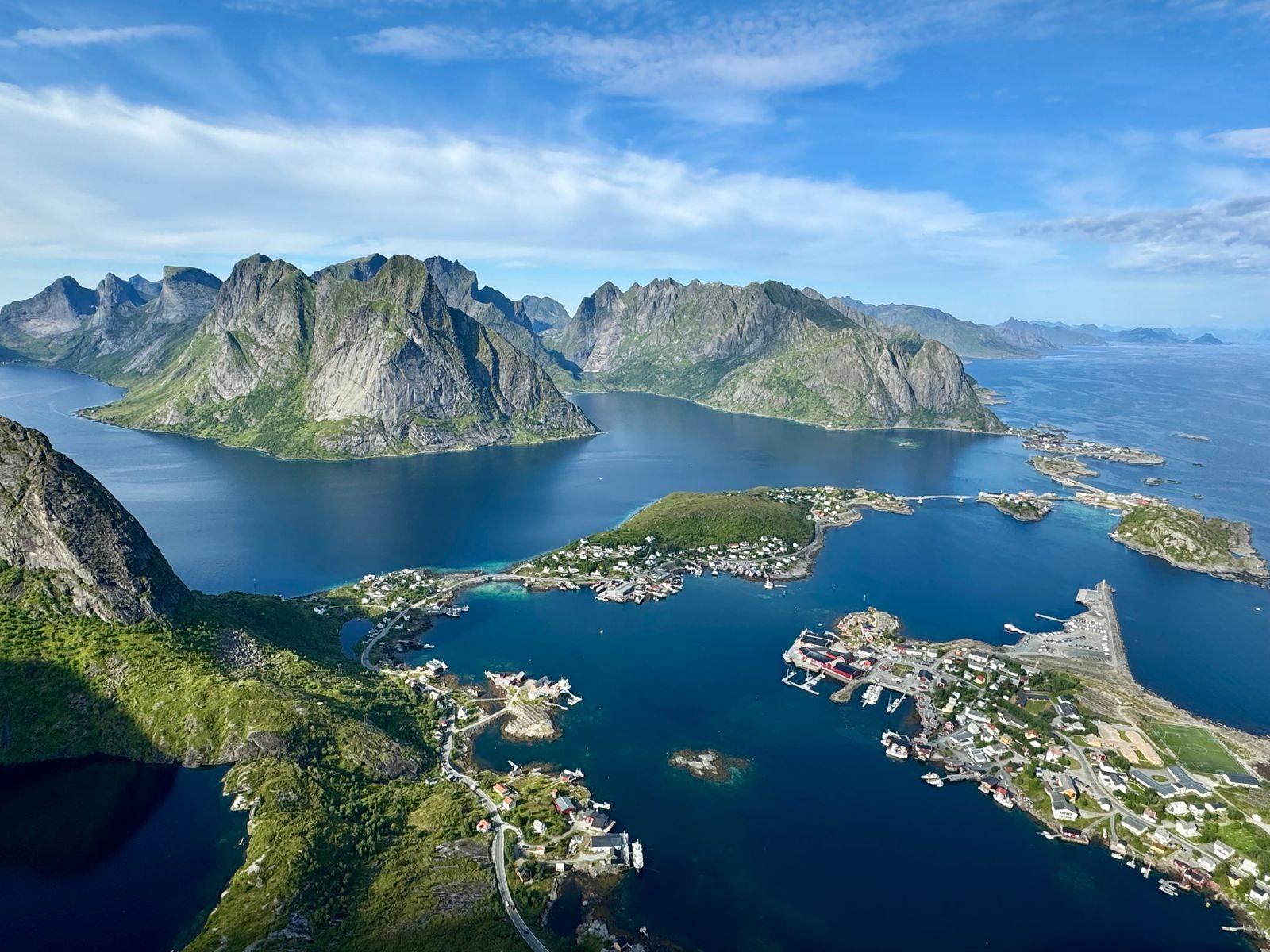 Stunning aerial view of Norwegian fjords in summer with turquoise waters and lush islands.