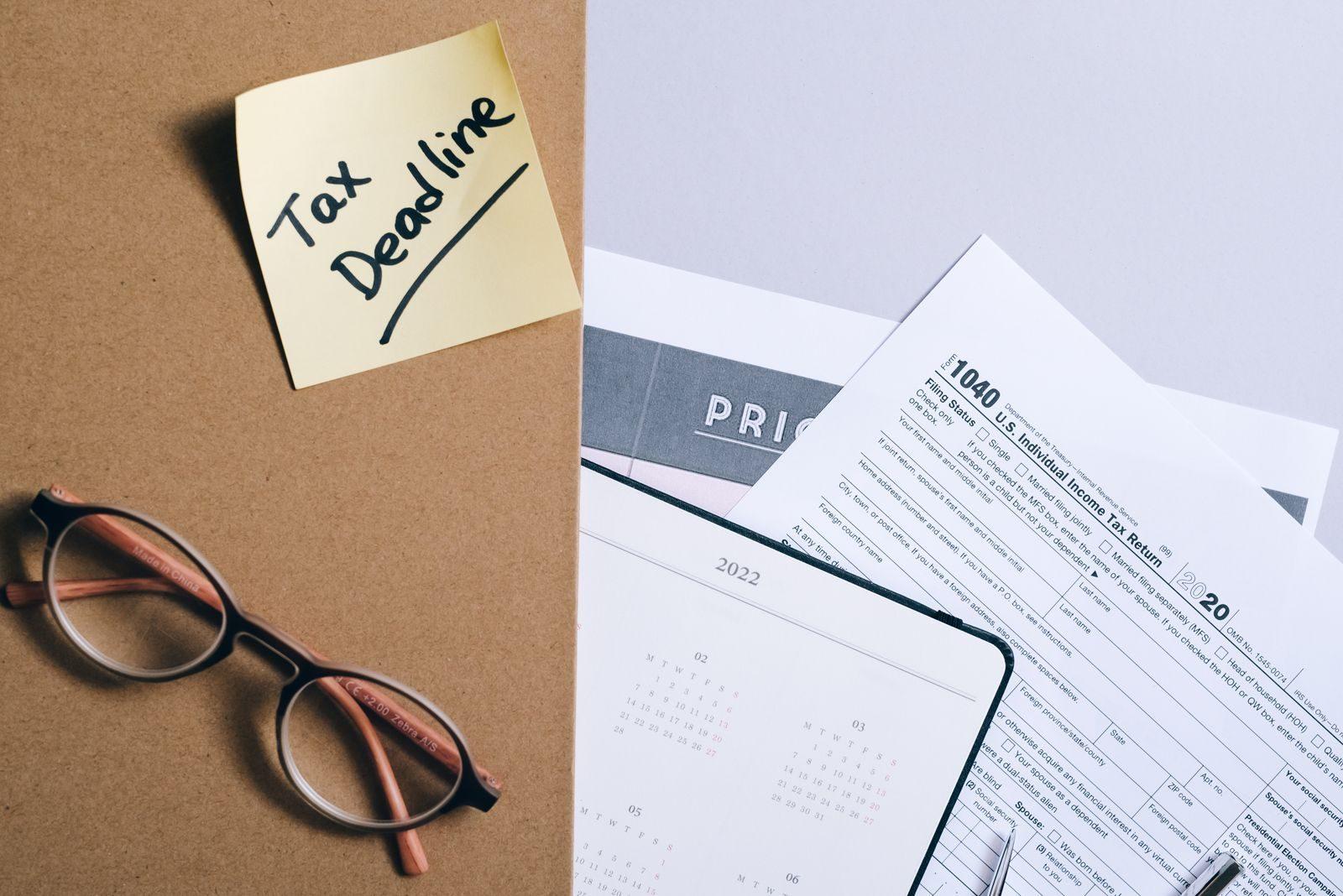 Organized tax preparation essentials with calendar, forms, and deadline reminder.